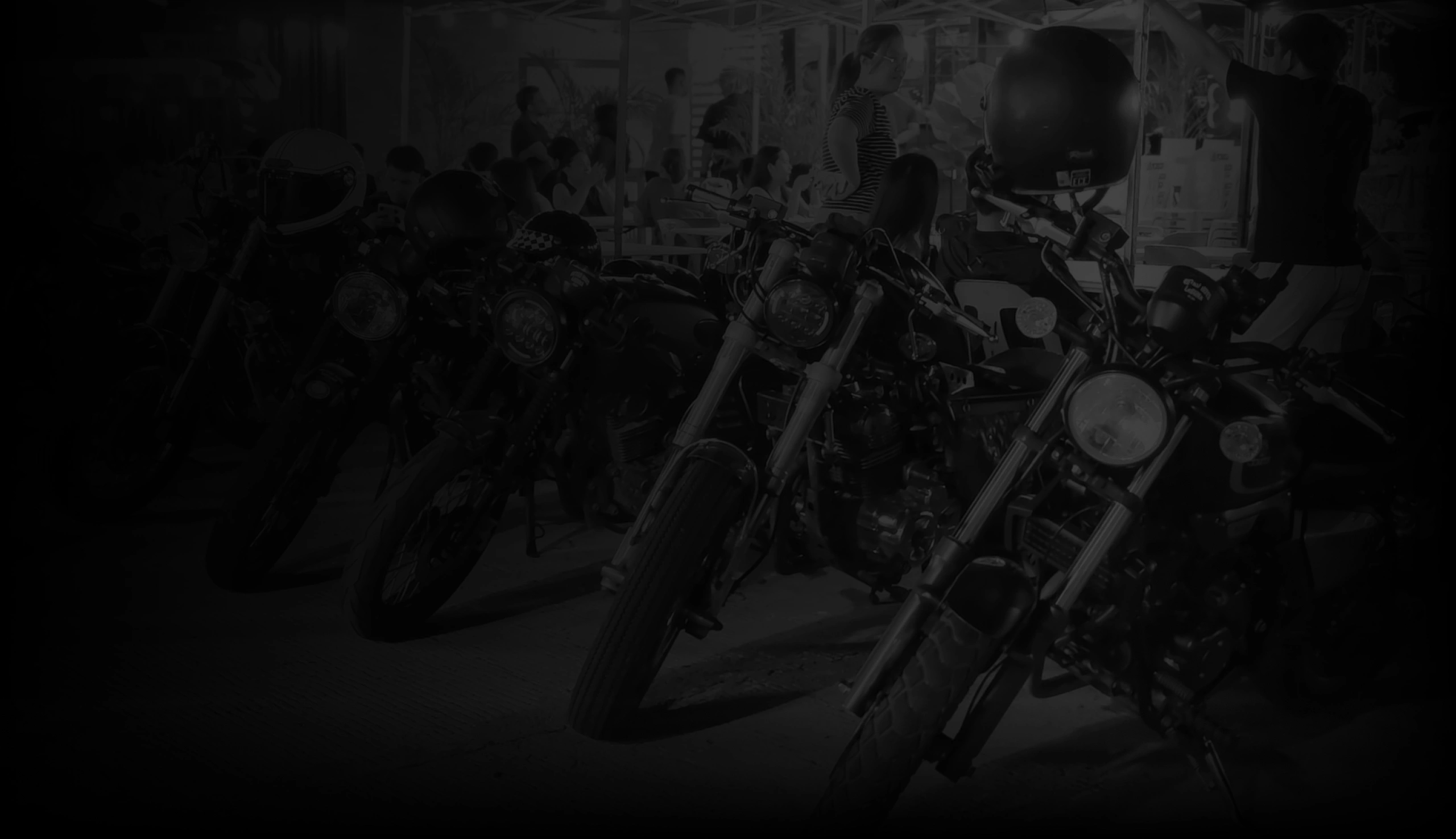 RBL motorcycles parked together during a busy Tambike gathering