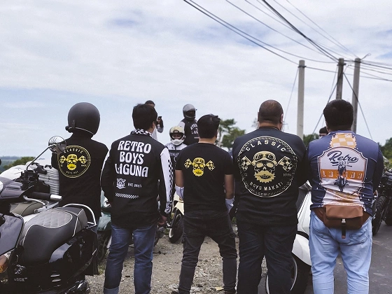 RBL members standing beside their motorcycles