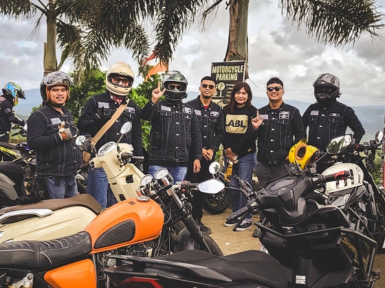 RBL riders posing with motorcycles at a scenic stop