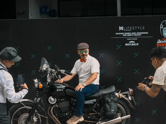Rider posing on a classic motorcycle